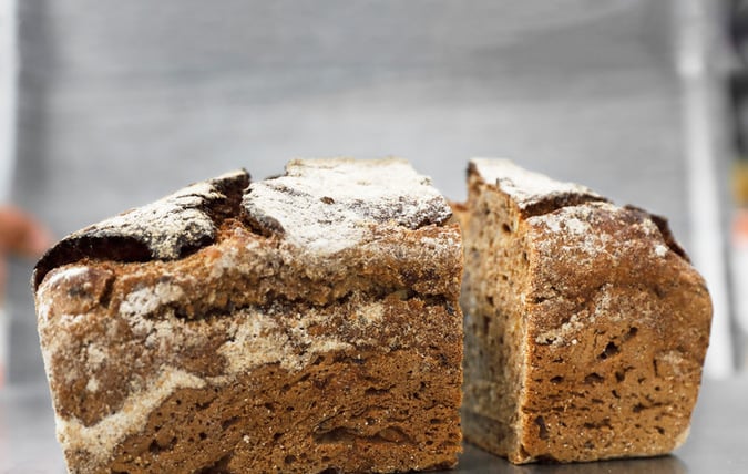 Loaf of bread cut into two pieces.